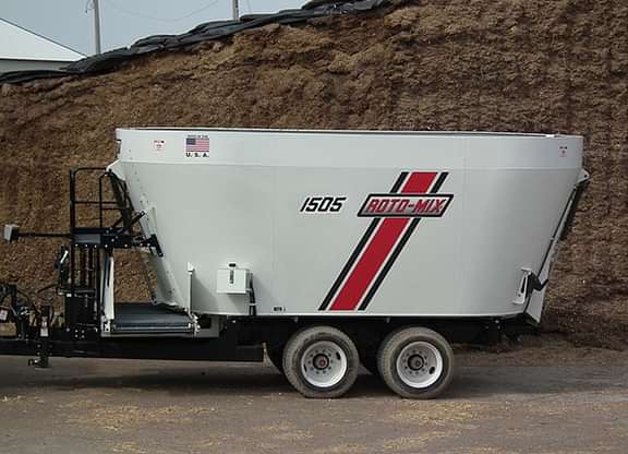 1505 trailer from the side with a silage pile in the back.