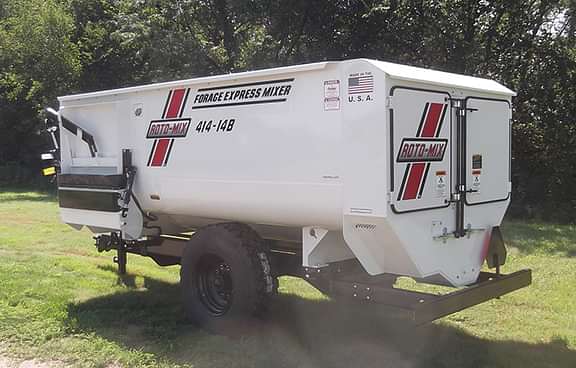 414 trailer sitting in the grass.